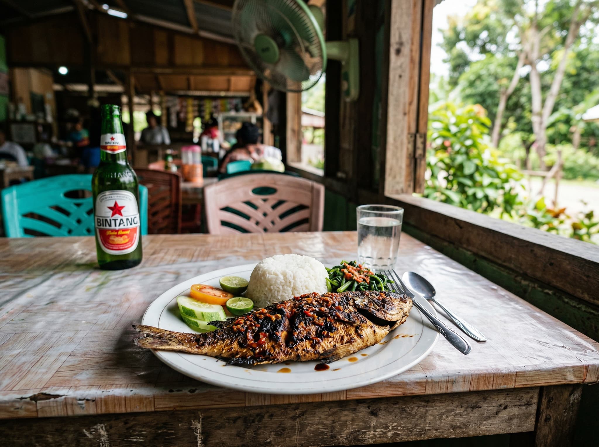 A simple Indonesian warung meal — nasi goreng or grilled fish — served at a small restaurant in Moni village, Flores, representing the basic but satisfying local food options available to travelers in this remote gateway village.