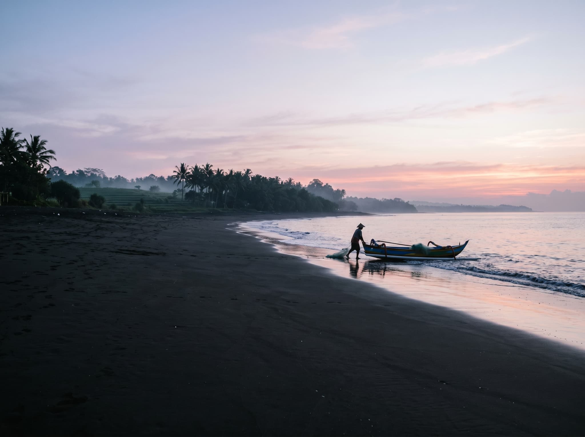 Seseh Beach at early morning with a fisherman and calm light — capturing the quiet dawn atmosphere the article describes as one of the best times to visit, before the day's heat and any villa guests arrive