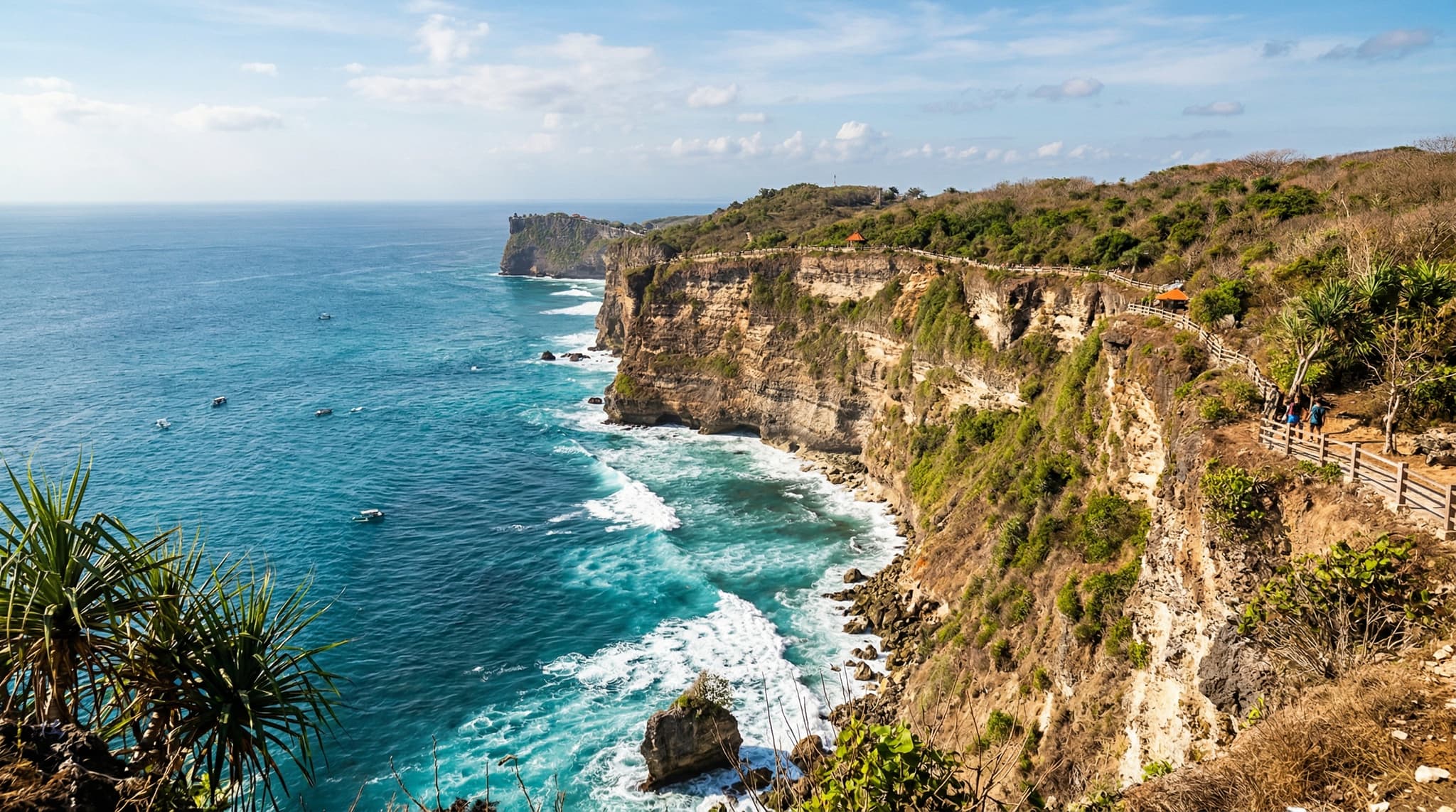 Dramatic limestone cliffs of the Bukit Peninsula dropping into the turquoise Indian Ocean, capturing the rugged, sun-bleached coastal landscape that defines Bali's southern tip — distinct from the lush volcanic scenery most visitors expect.