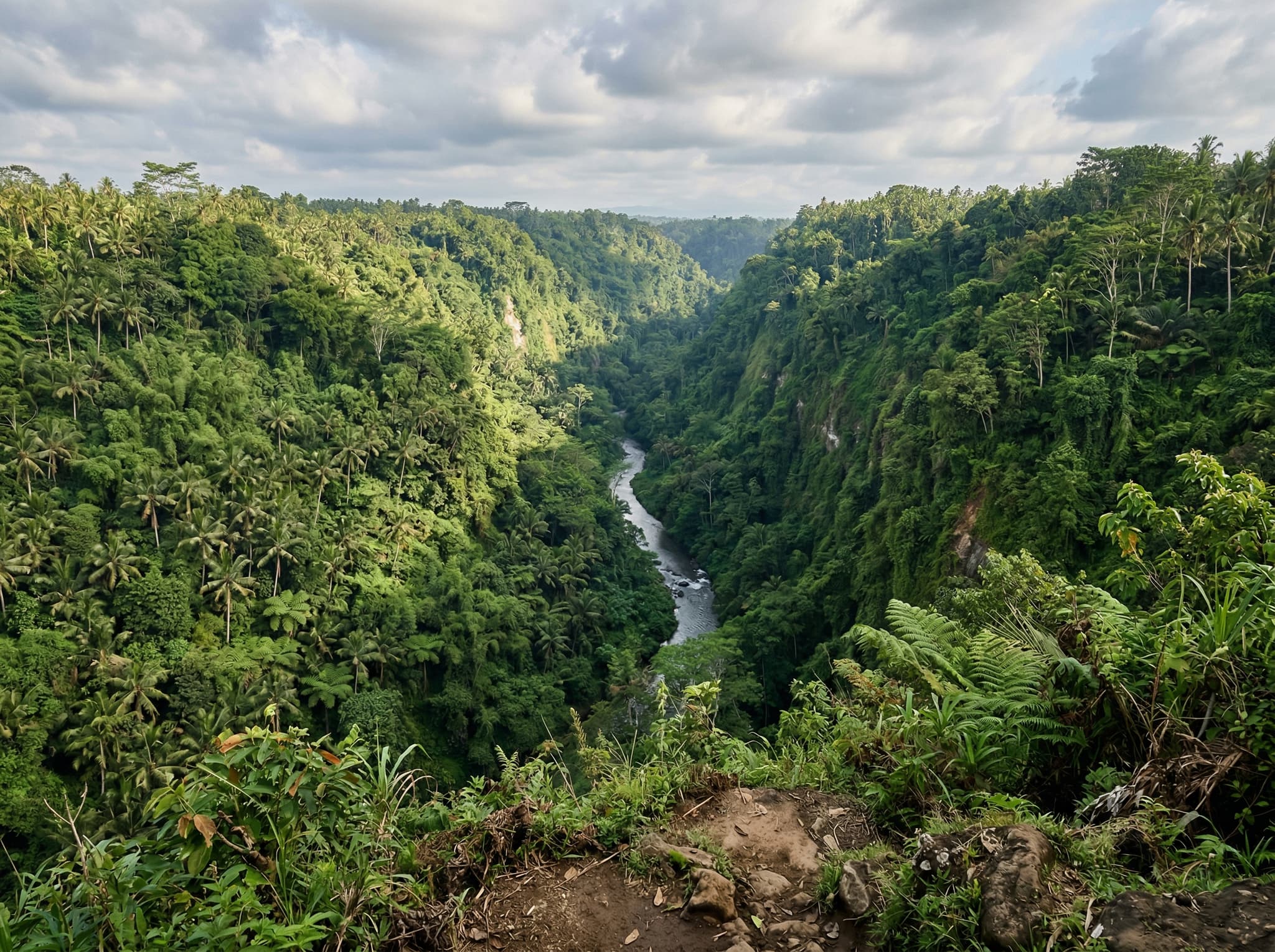 Sayan ridge overlooking the Ayung River gorge — a dramatic valley view with dense jungle canopy and the river far below, illustrating the article's description of Sayan as Ubud's luxury retreat corridor defined by its gorge views