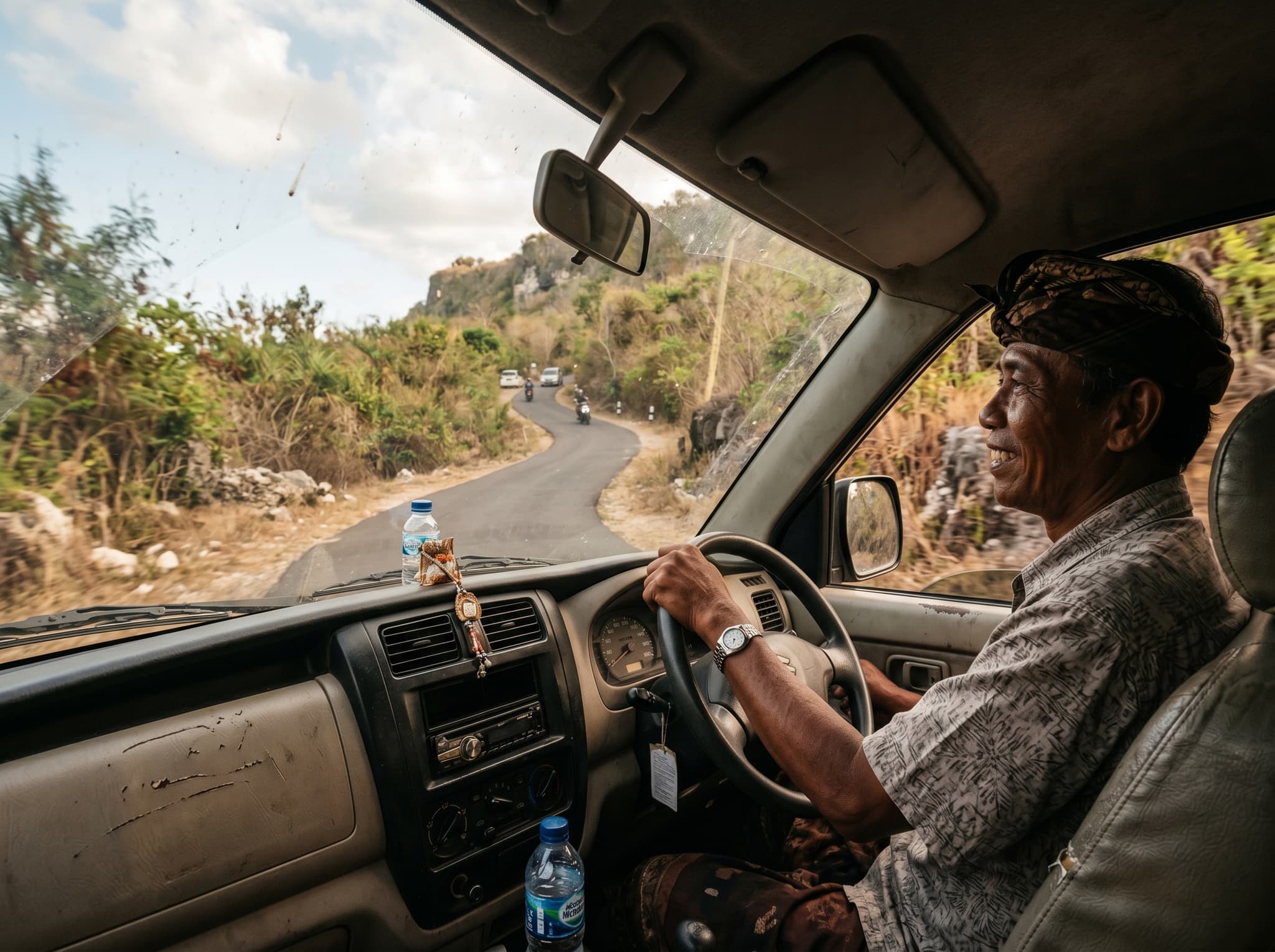 A driver or taxi on the road between Nusa Dua and Uluwatu, Bali — illustrating the article's practical advice to hire a full-day driver to explore beyond the resort enclave