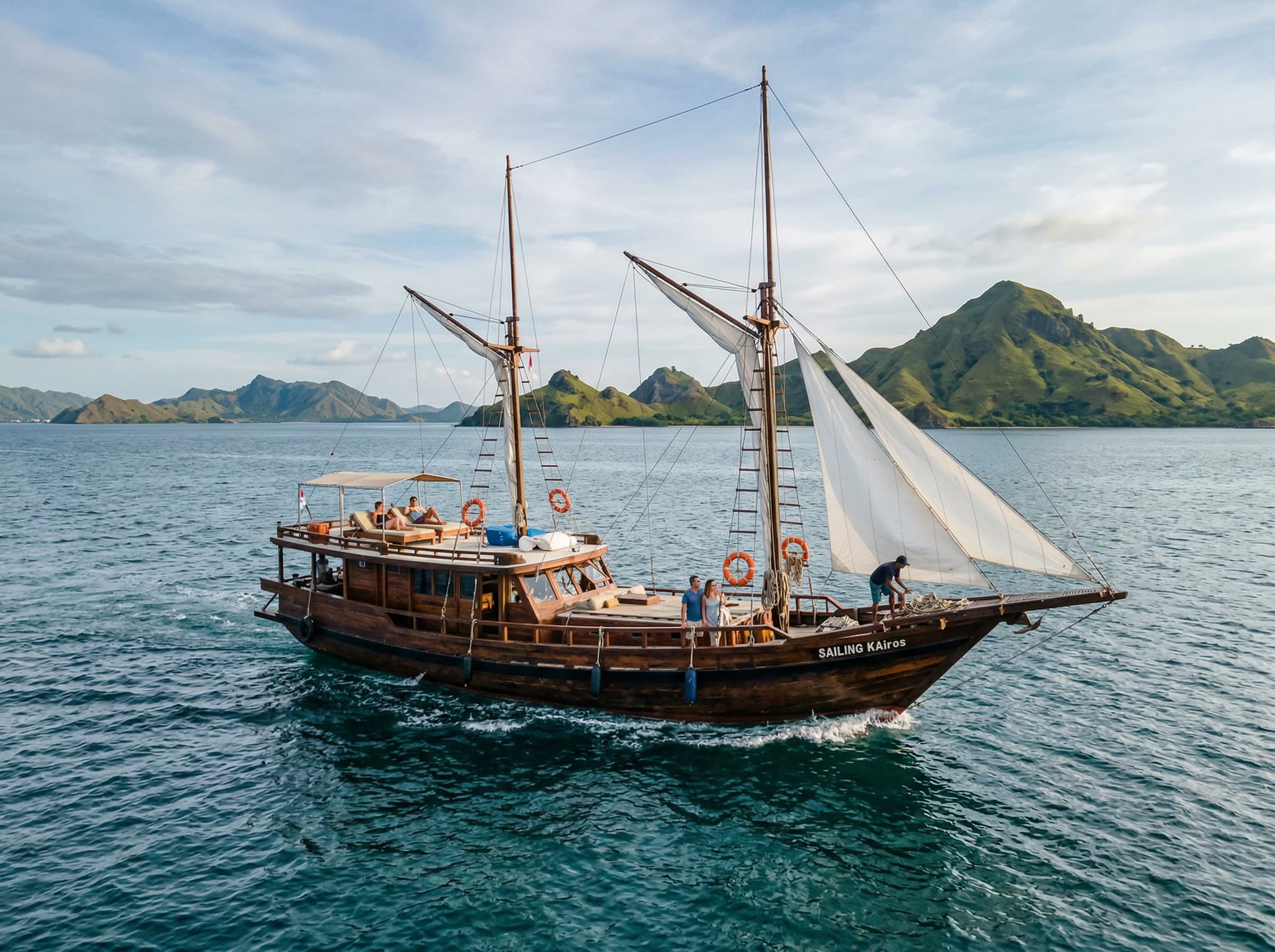 A wooden dive boat on the open water between Labuan Bajo and Komodo National Park, representing the three-hour boat journey visitors must make to reach Manta Point