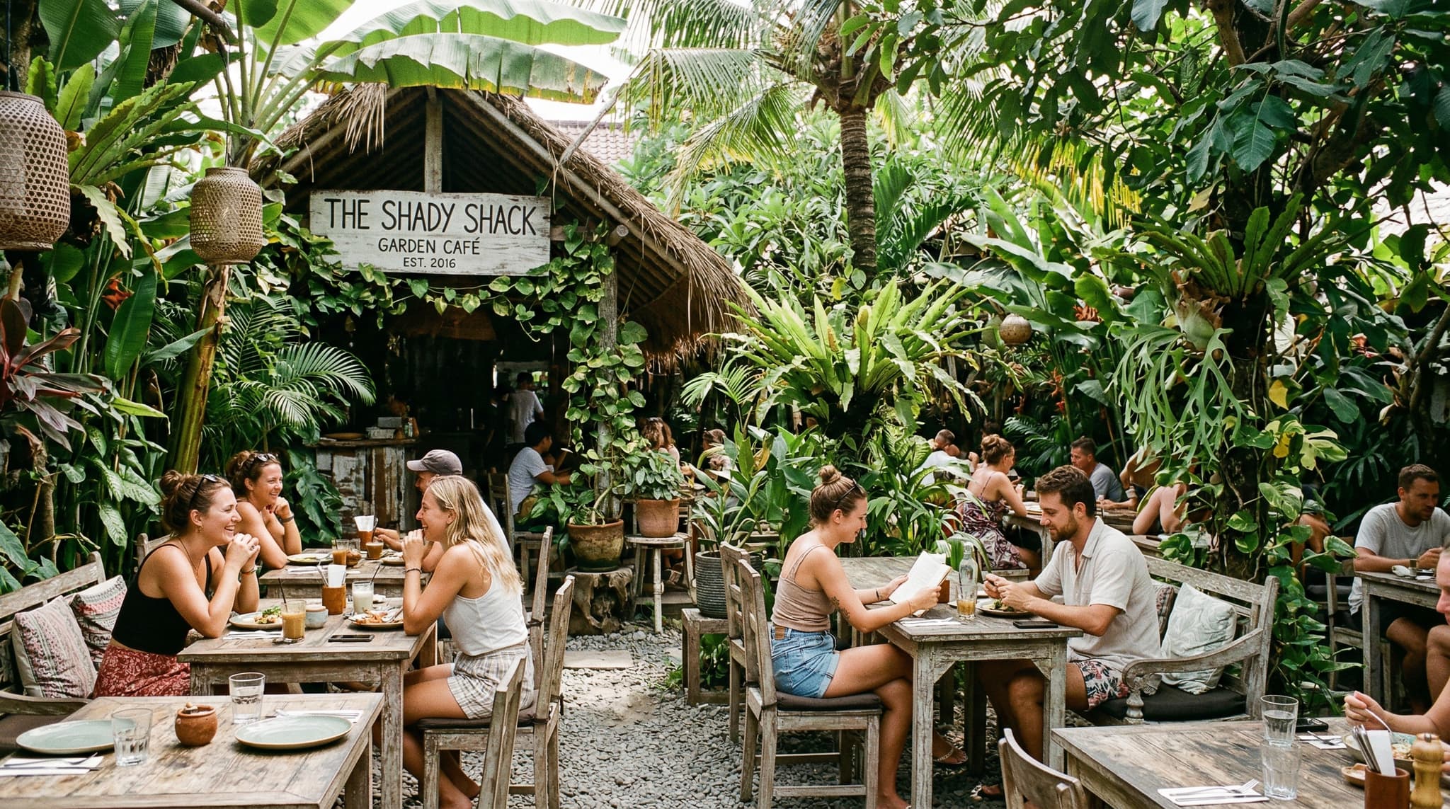 Shady Shack café in Canggu, Bali — the garden seating area surrounded by tropical greenery, showing the open-air dining atmosphere that defines this long-running vegetarian café on Jalan Tanah Barak