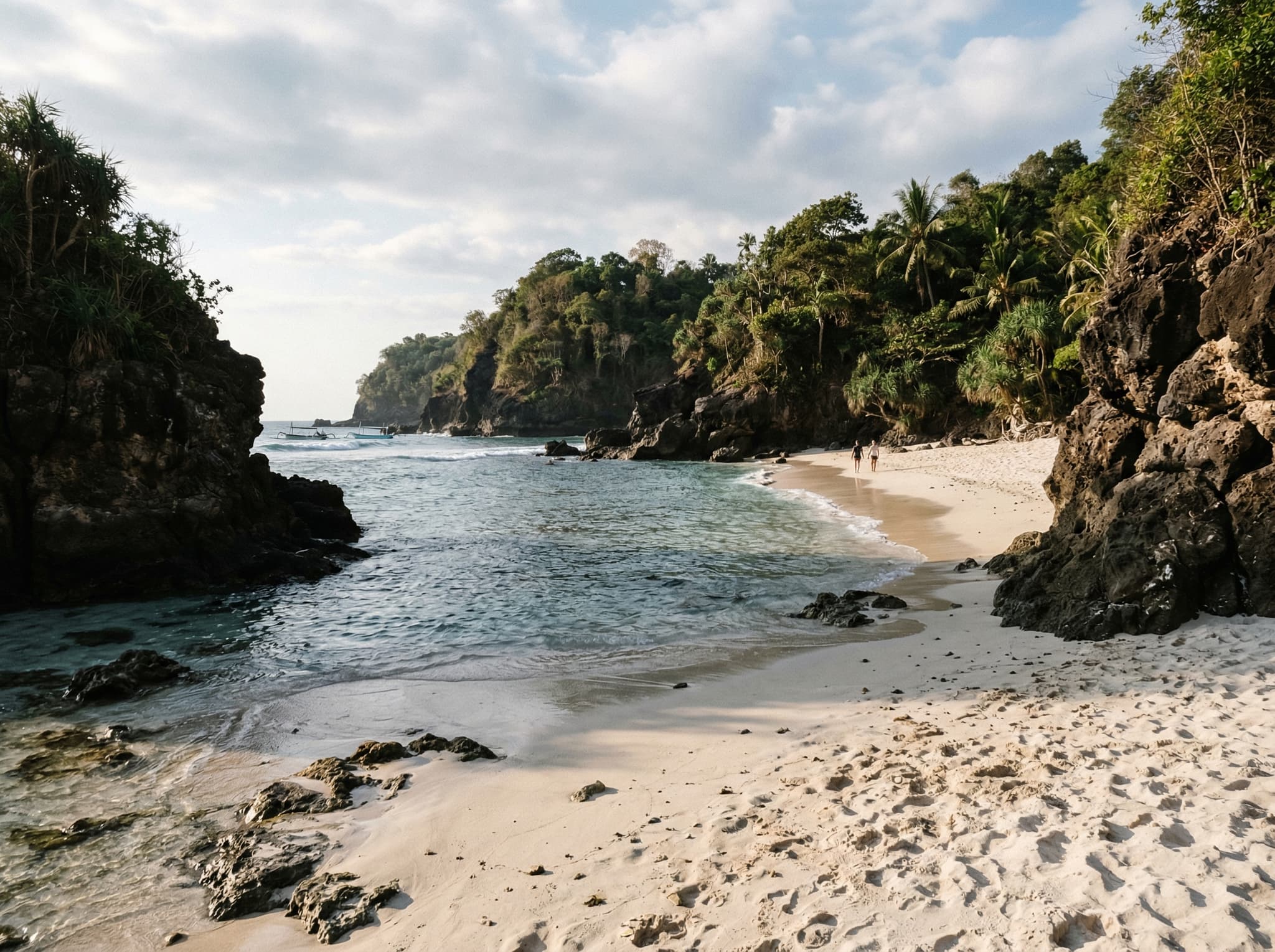 Bias Tugel Beach (Secret Beach) in Padang Bai — a pristine, narrow strip of white sand flanked by rocky headlands, showing the nearby alternative beach the article recommends combining with Blue Lagoon in a half-day visit