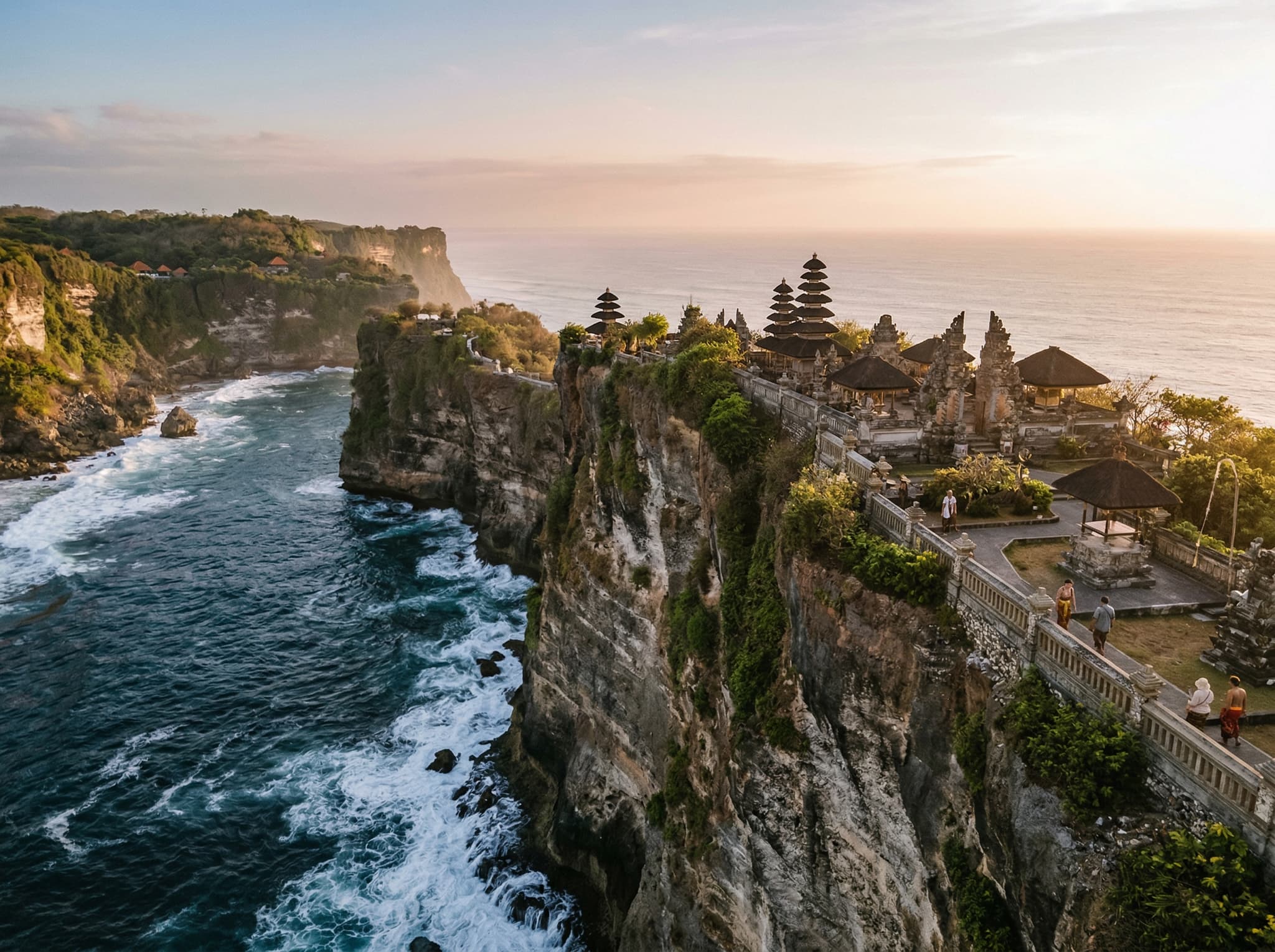 Uluwatu Temple perched on its clifftop above the Indian Ocean — referenced in the article as a practical pairing with GWK for an afternoon itinerary on the Bukit Peninsula, and as the comparison point for Kecak performance atmosphere