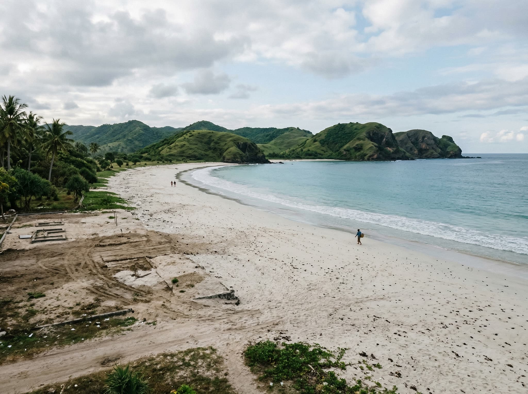 The beach at Tanjung Aan in its current in-between state — beautiful natural setting with visible signs of change, capturing the honest, complicated character the article's closing section describes