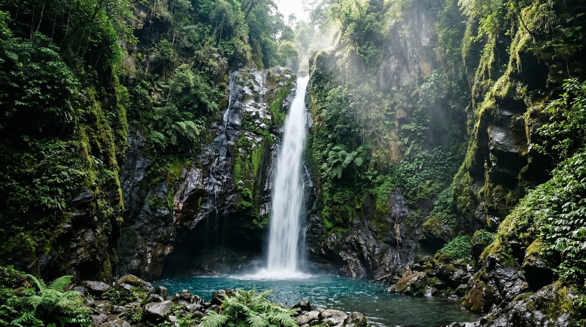 Mangku Sakti Waterfall cascading down dark volcanic rock into a cold pool in a narrow jungle gorge on the lower slopes of Mount Rinjani, Sembalun, Lombok — the primary subject of this article
