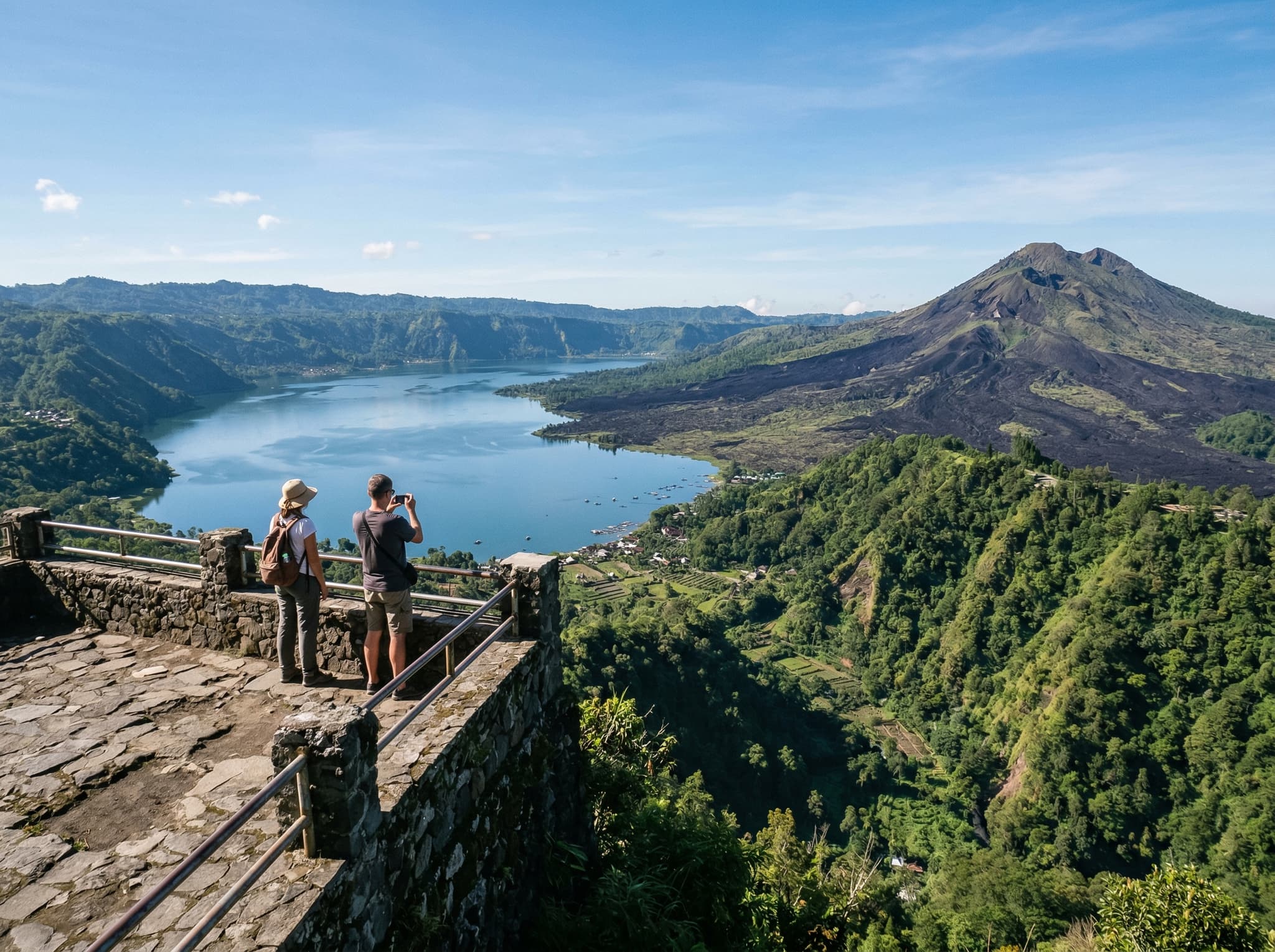 Penelokan viewpoint on the Kintamani caldera rim with the volcano and lake panorama spread below, showing the accessible daytime alternative to the sunrise trek described in the article