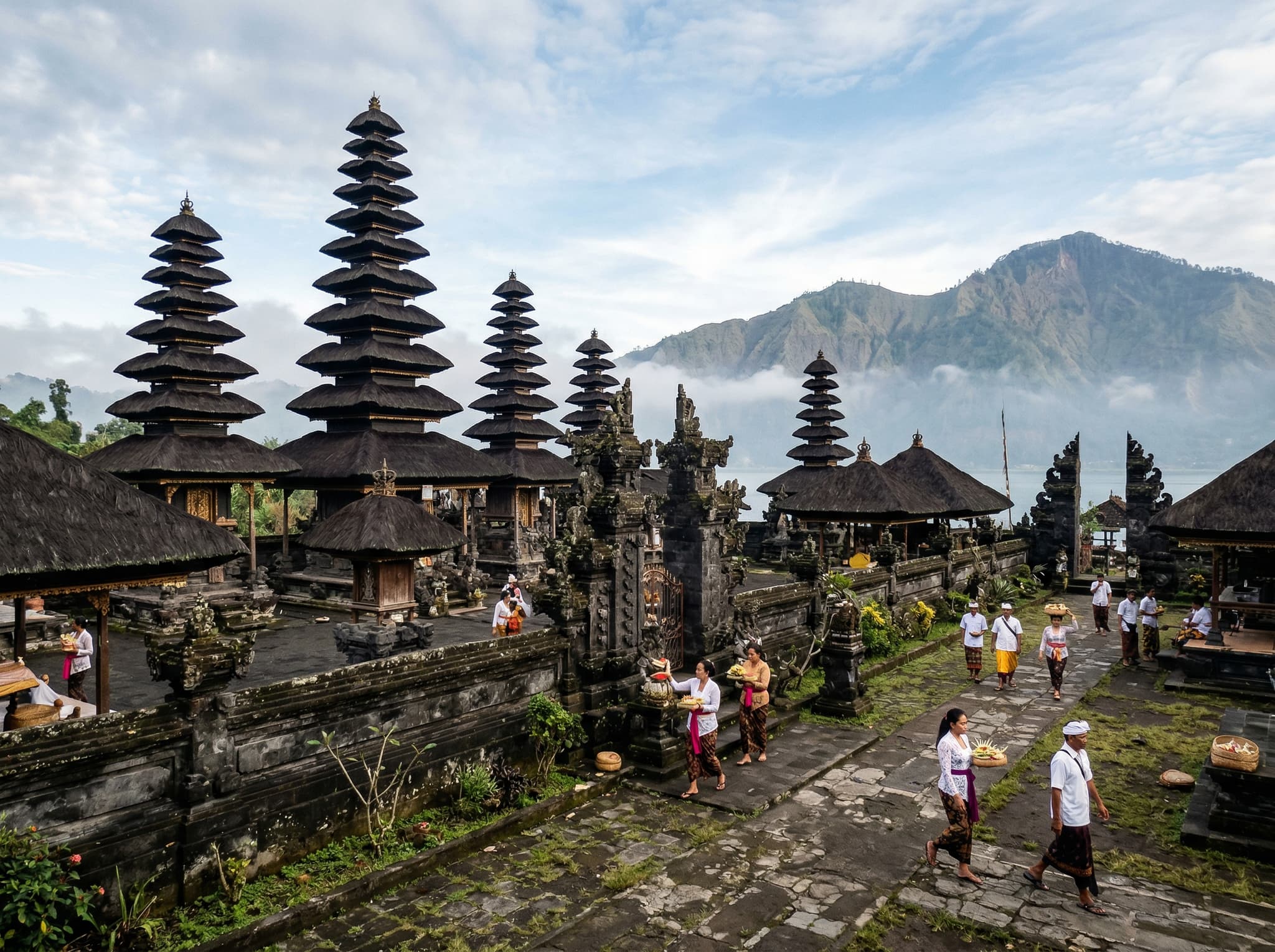 Pura Ulun Danu Batur temple in the Kintamani highlands, showing its tiered black-thatched meru shrines against the highland sky — one of the key cultural sites mentioned in the article alongside the volcano and coffee