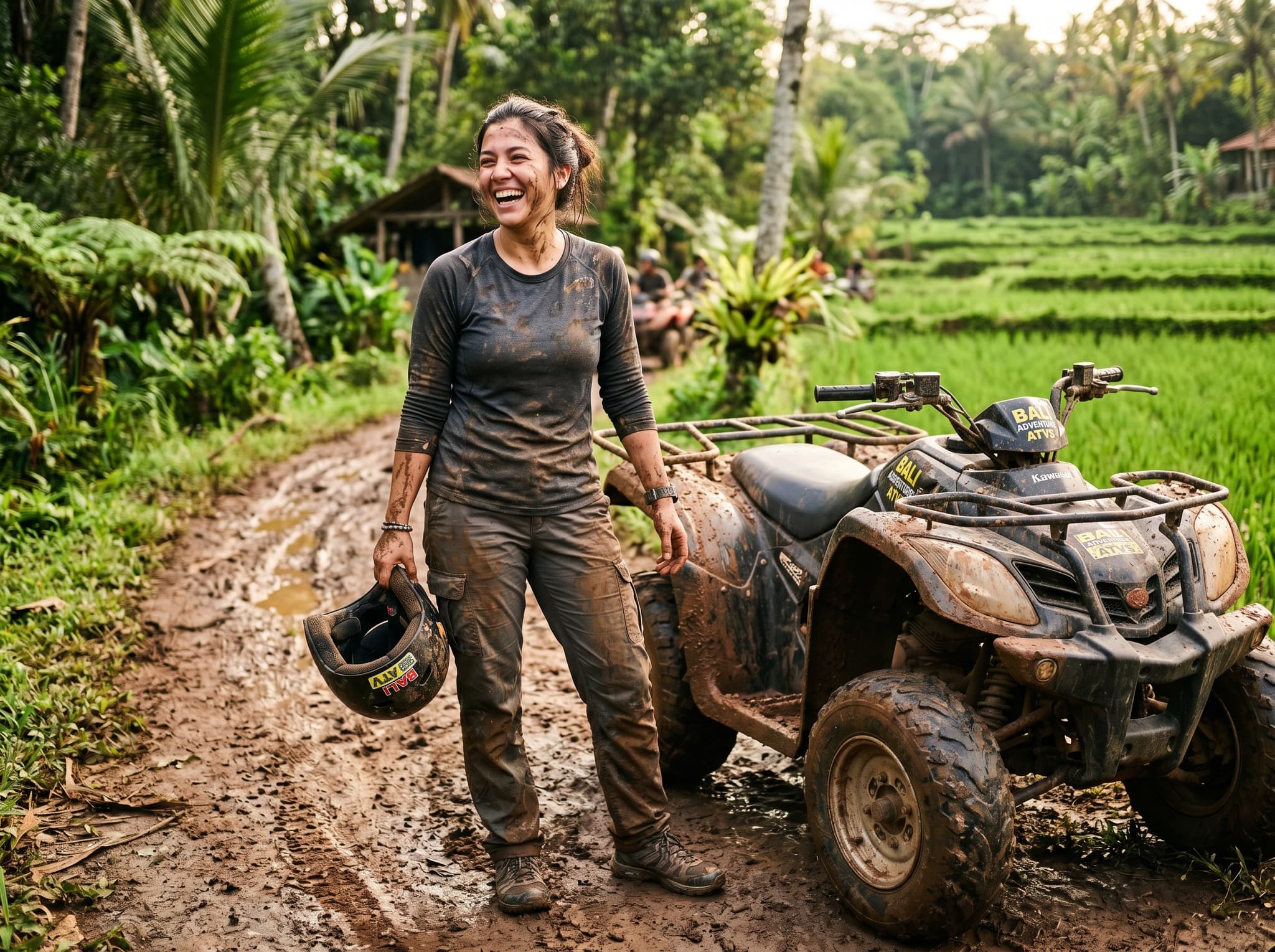 A rider covered in mud after completing an ATV trail ride in Bali, laughing and holding a helmet — conveying the honest, messy, fun reality of the experience as described in the 'What to Wear' section