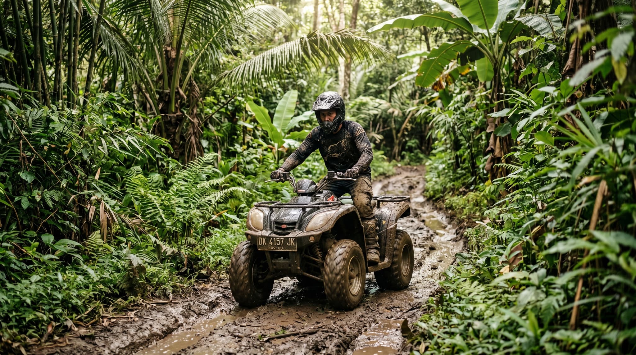 A rider on an ATV quad bike navigating a muddy jungle trail through dense tropical vegetation in Bali, Indonesia — illustrating the hands-on, adventurous nature of the ATV experiences reviewed in this guide