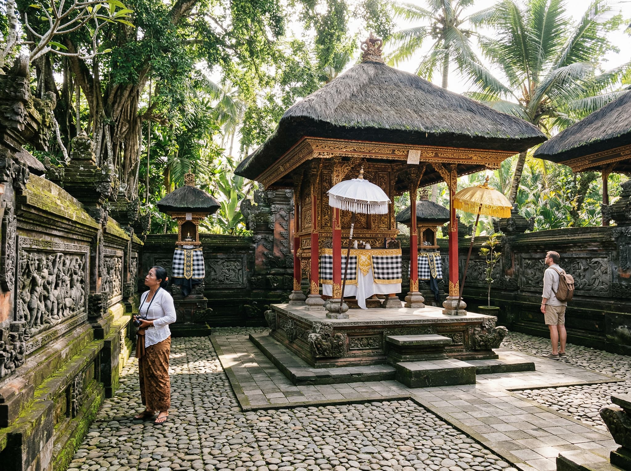 A traditional Balinese palace courtyard interior showing open-air pavilions with intricate woodwork and carved stone architecture — illustrating the spatial philosophy and craftsmanship that defines Puri Saren Agung's accessible areas
